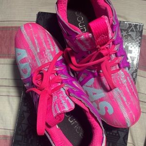 Pink workout shoes by the brand Adidas